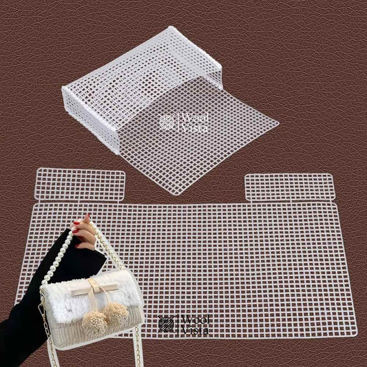 Hand holding the assembled white plastic mesh flap shoulder bag
