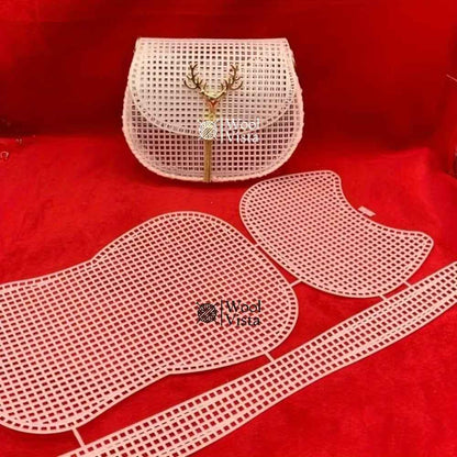 White plastic mesh sheet with pre-cut saddle bag pieces and a finished crossbody bag with deer charm, on red background