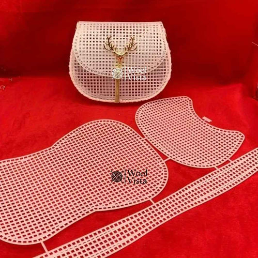 White plastic mesh sheet with pre-cut saddle bag pieces and a finished crossbody bag with deer charm, on red background