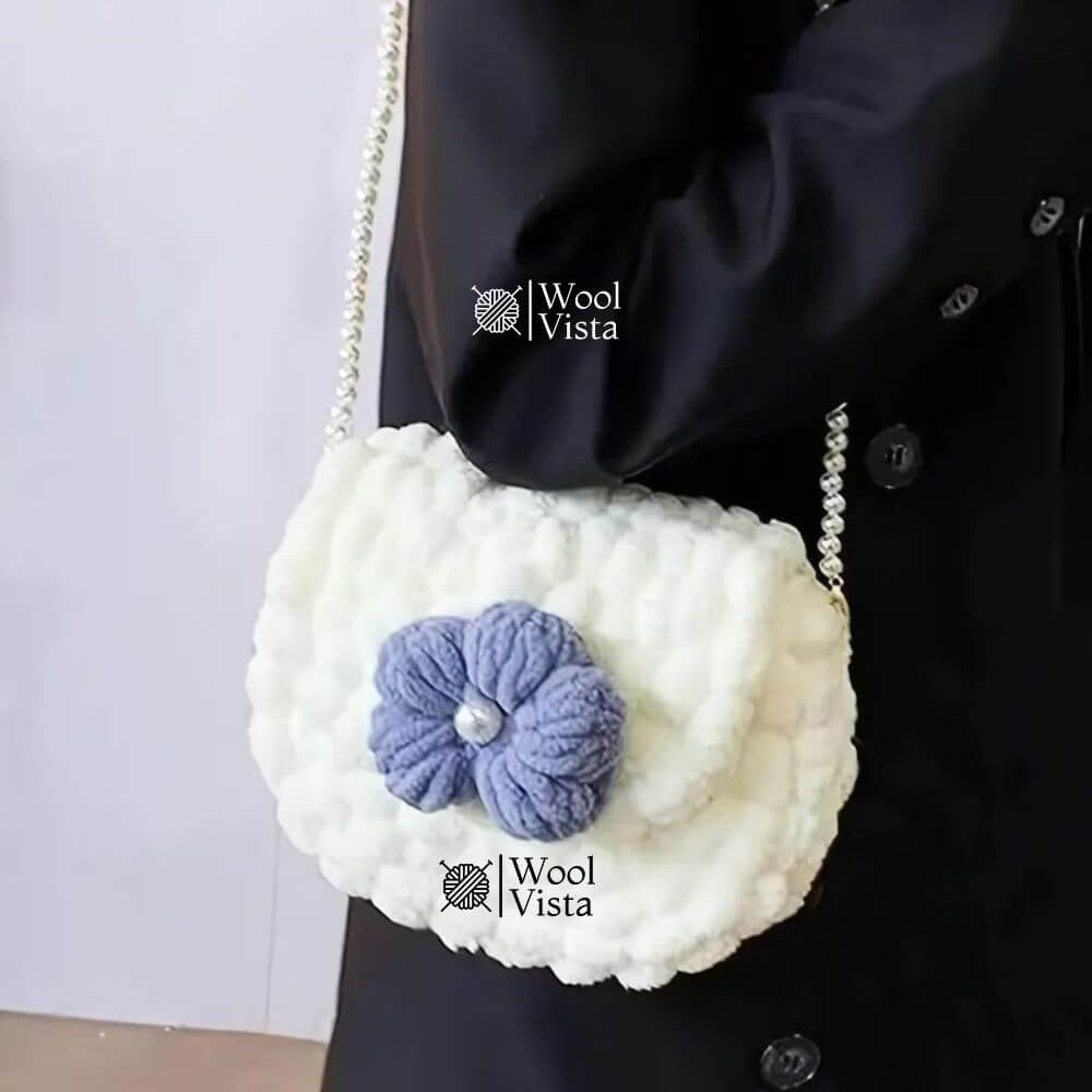 Finished white chunky crochet crossbody bag with blue flower and pearl strap made on a mesh sheet base